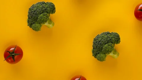 Cauliflower, Broccoli and Tomato, stop motion animation on yellow background 4k  Video stock 129039769