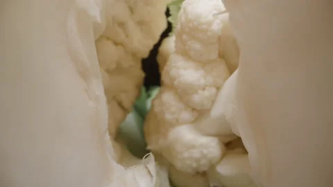 Cauliflower, broken in half, camera inside. Dolly slider extreme close-up. Stock Footage 221982343