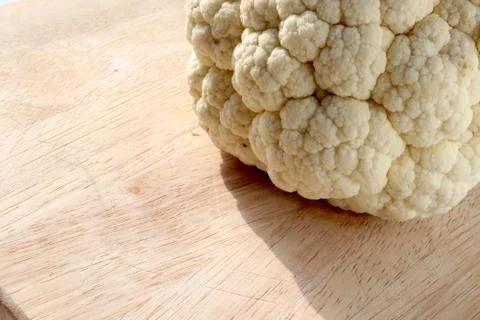 Cauliflower on chopping board Stock Photos