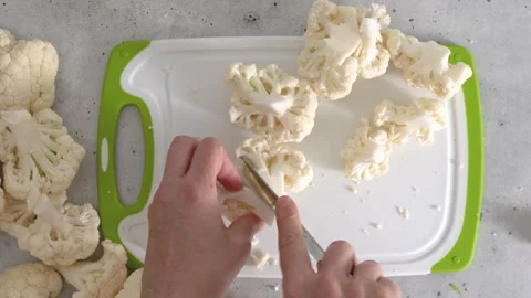 Cauliflower close-up on cutting board on kitchen table Stock Footage 266563673