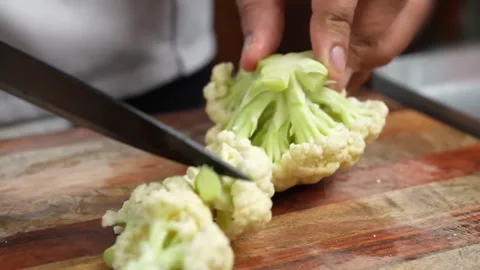 Cauliflower Cutting on board in kitchen room Video stock 286866085