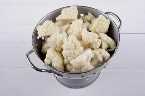Cauliflower florets in a colander Stock Photos