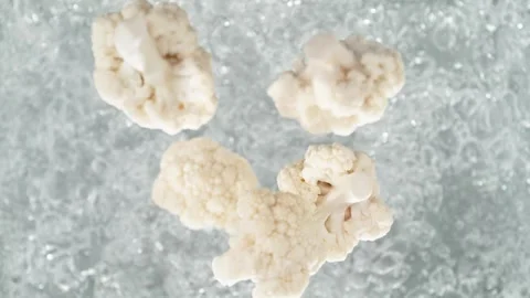Cauliflower Florets Falling into Pot of Boiling Water Stock Footage 271398920