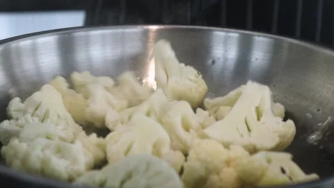 Cauliflower in a frying pan in the kitchen, close-up Stock Footage 153543382