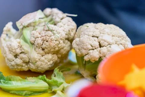 Cauliflower Laying on Kitchen Table Фото