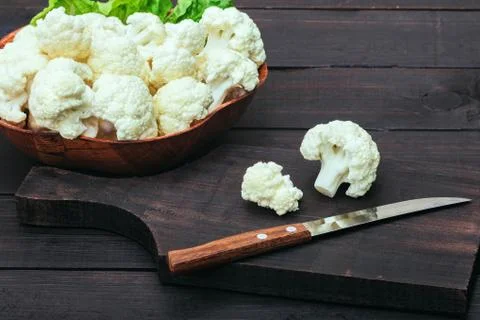 Cauliflower on the table. Cutting board whith sharp stainless knife 写真素材