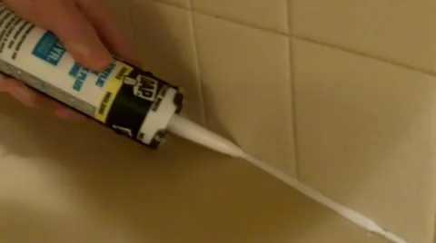 Caulking countertop and tile backsplash Stock Footage 44789195