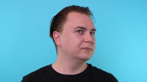 Causacian man with looking at the camera and beating a slap in the face Stock Footage 115664565