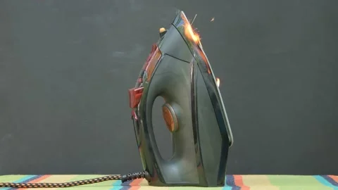 The cause of the fire is overheating of the iron. Ignition of an electric iron i Video stock 201930249