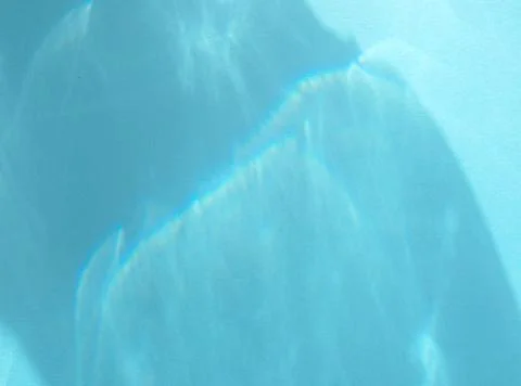 Caustic effect, play of shadows on blue background Stock Photos