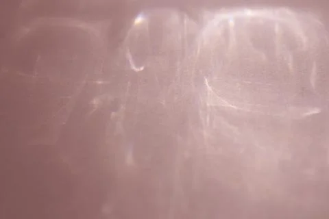 Caustic effect, play of shadows on a peach background Stock Photos