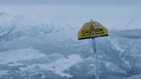 Caution avalance danger sign on top of a mountain in Revelstoke British Columbia Stock Footage 160810491