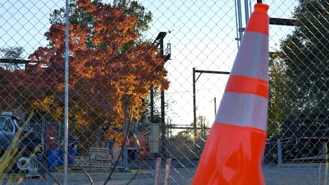 Caution cone in front of chainlink fence electrical station Stock Footage 118464001
