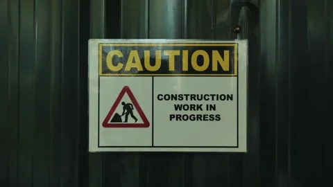 Caution Construction Work In Progress Sign On Industrial Metal Background Scene Stock Footage 332656389