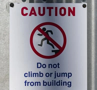 Caution, do not climb or jump from building sign Stock Photos