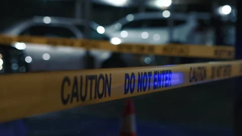 Caution do not enter tape at night on parking lot with police lights flashing Stock Footage 346061749