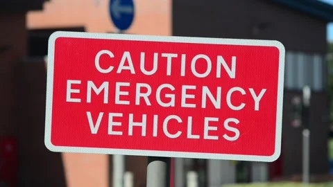Caution emergency vehicles warning sign outside fire station Stock Footage 138374756