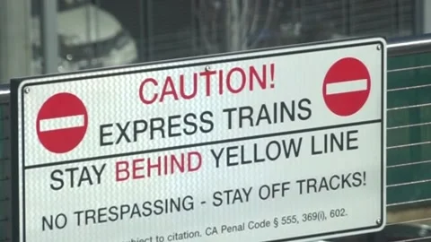 Caution! Express Trains Stay Behind Yellow Line sign Stock Footage 236536060