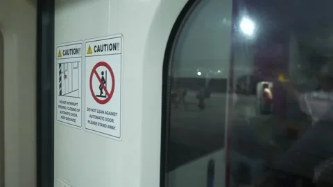 Caution graphics inside the Vande Bharat train automatic entry and exit door Stock Footage 295831676