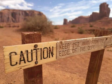 Caution. Keep away from the edge of the cliff. Monument Valley Stock Photos