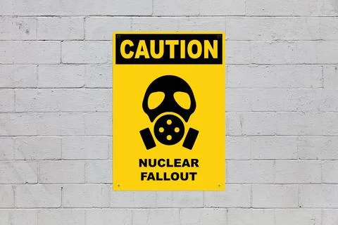 Caution, Nuclear fallout sign on a cinder block wall Stock Photos