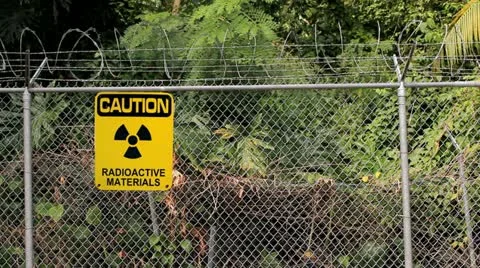Caution radiation sign materials perimeter fence Stock Footage 21887589