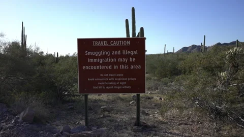 Caution sign about illegal immigration and smuggling in the area Stock Footage 237014622