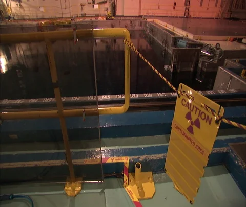 Caution sign and pool inside nuclear power station Stock Footage 86692959