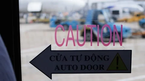 Caution sign on bus door. Background airport. Stock Footage 270683115