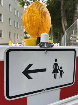 Caution Sign Featuring a Pedestrian Direction Indicator for Enhanced Safety Stock Photos