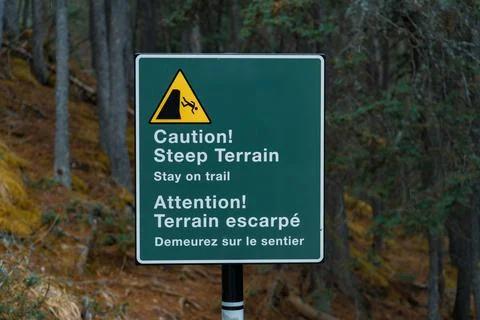Caution sign indicating steep terrain ahead Stock Photos