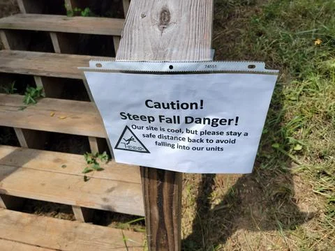 Caution steep fall danger sign on stairs or steps Stock Photos