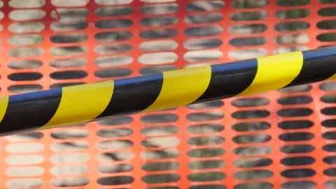 Caution tape behind a orange mesh fence Stock Footage 345536491
