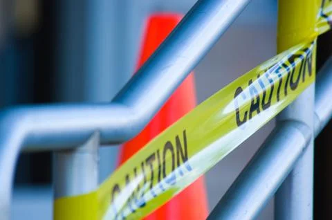 Caution tape with orange traffic cone Stock Photos