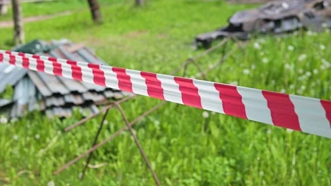 Caution tape is used to mark off an area under construction in a grassy field. Stock Footage 339004271