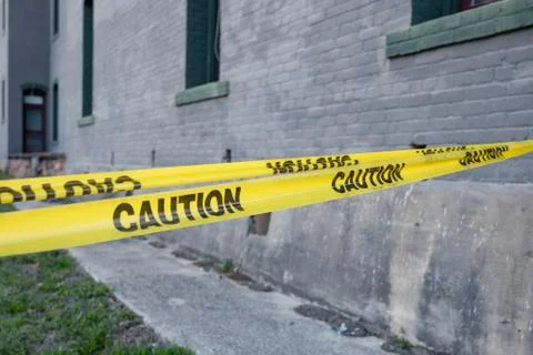 Caution tape yellow sections off an area for safety access Stock Photos