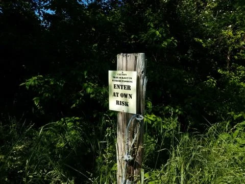 Caution trail subject to flooding enter at own risk sign Stock Photos