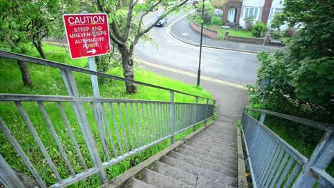 Caution warning sign of steep and uneven steps selby united kingdom Stock Footage 171322757