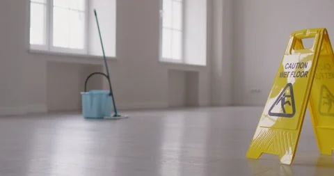 Caution wer floor yellow sign to minimise slips, trips and falls after washing Stock Footage 307920079
