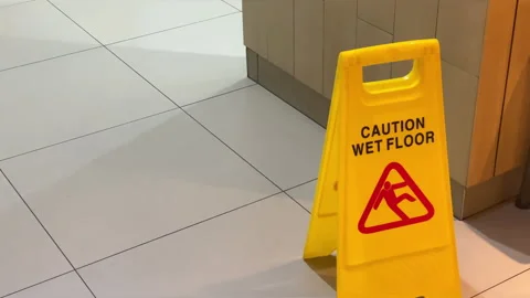 "Caution Wet Floor" sign on a clean tiled floor. Stock Footage 288400600