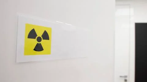 CAUTION: X-RAY IN USE warning sign posted on open door to dental room. Stock Photos