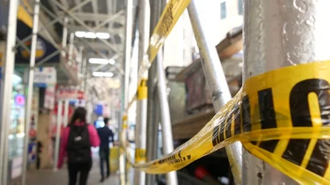 Caution yellow tape, construction scaffolding in Manhattan, New York USA Stock Footage 327143155