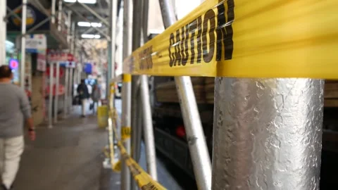 Caution yellow tape, construction scaffolding in Manhattan, New York USA Stock Footage 329282192