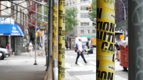 Caution yellow tape, construction scaffolding in Manhattan, New York USA Video stock 337424726