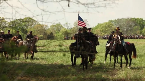Cavalry riders in procession flying flags and guidons pass Stock Footage 39982232