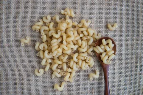 Cavatappi raw pasta on rustic background . Natural and healthy food concept. Stock Photos