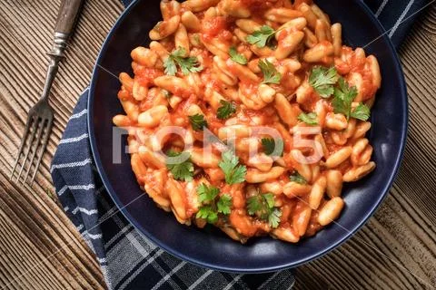 Cavatelli pasta with fresh tomato sauce. Stock Photos