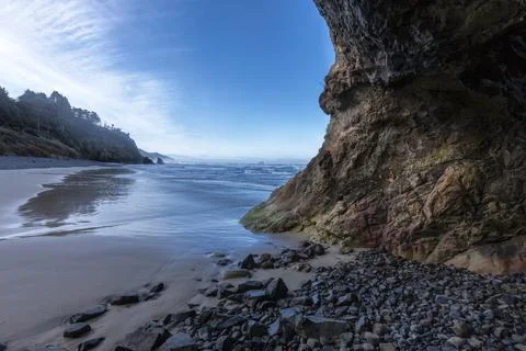 In a cave at beach by ocean. Stock Photos