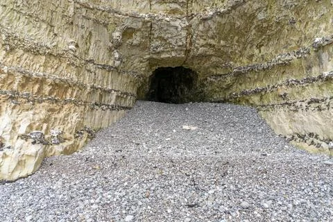 Cave in a chalk cliff Stock Photos