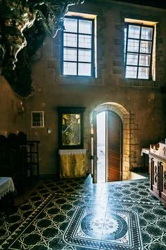 Cave church interior with window light and doorway, Crete, Greece Stock Photos